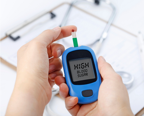 Hand holding blood glucose meter measuring blood sugar background is stethoscope chart